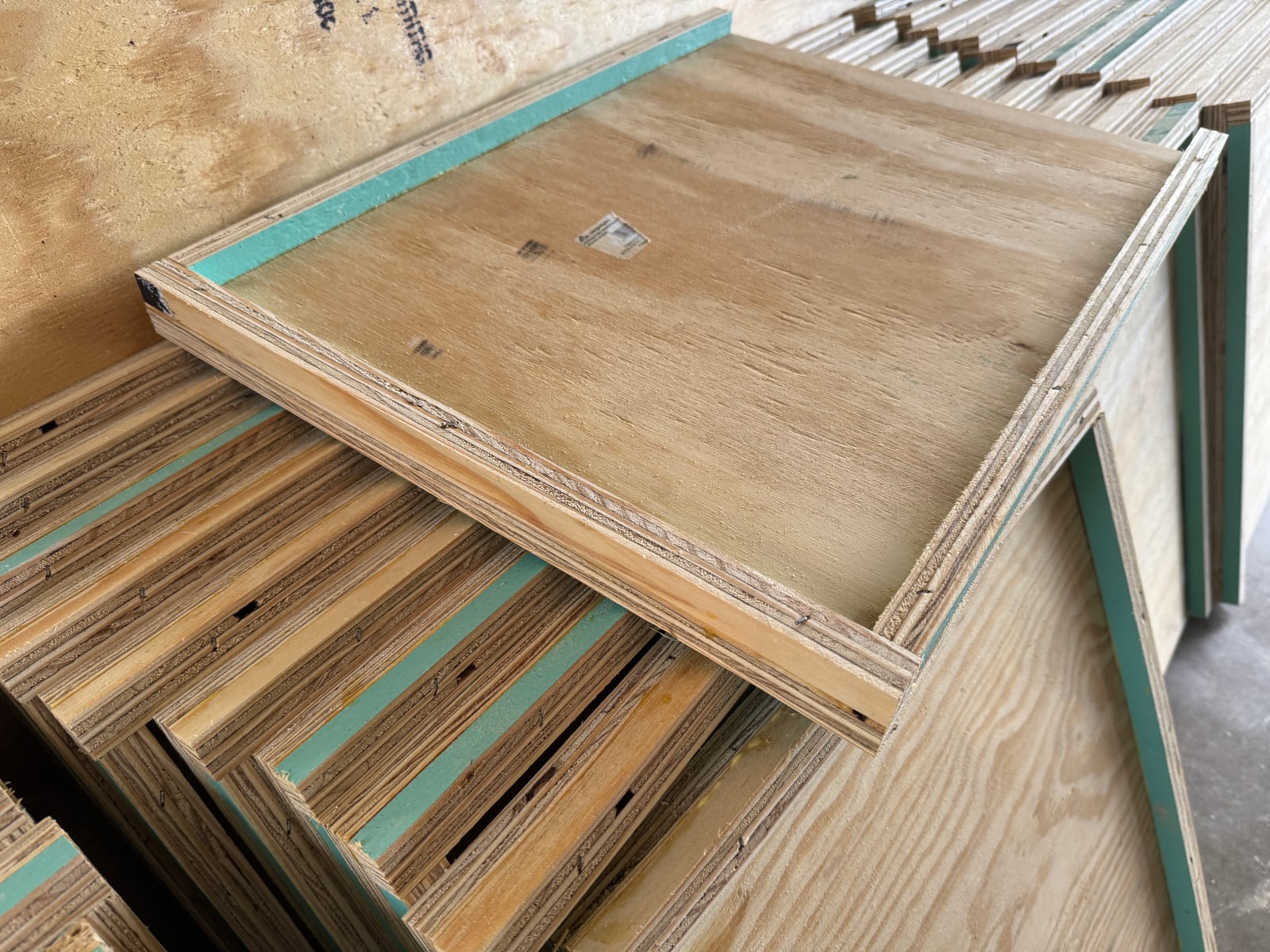 Locally built 10-frame bottom boards stacked in the Bee To Z workshop